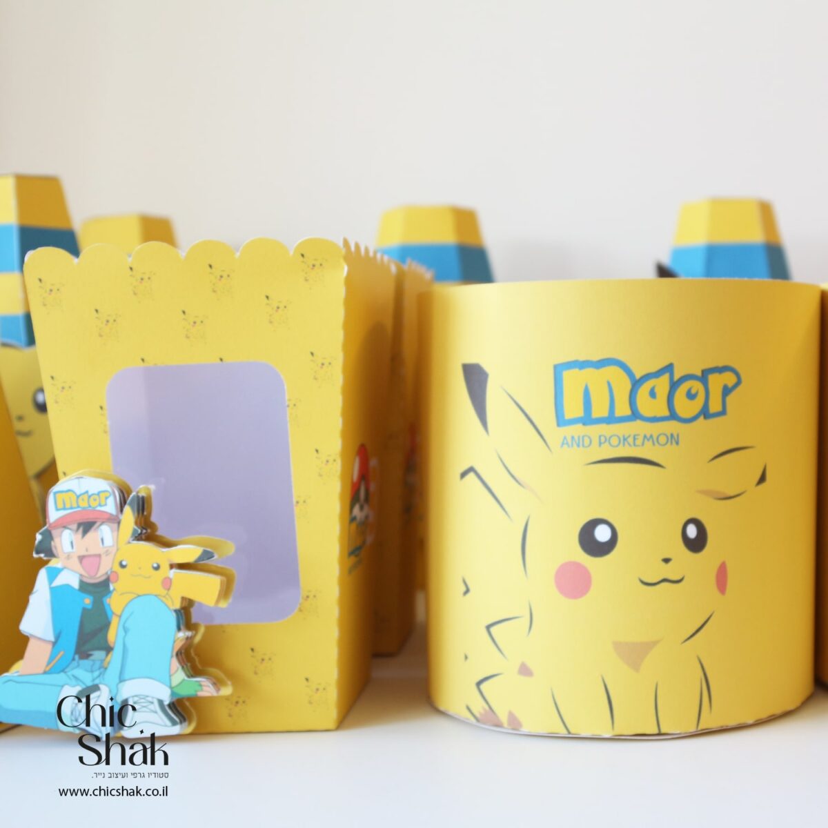 קופסאות פופקורן ומרכזי שולחן עגולים בעיצוב פוקימון